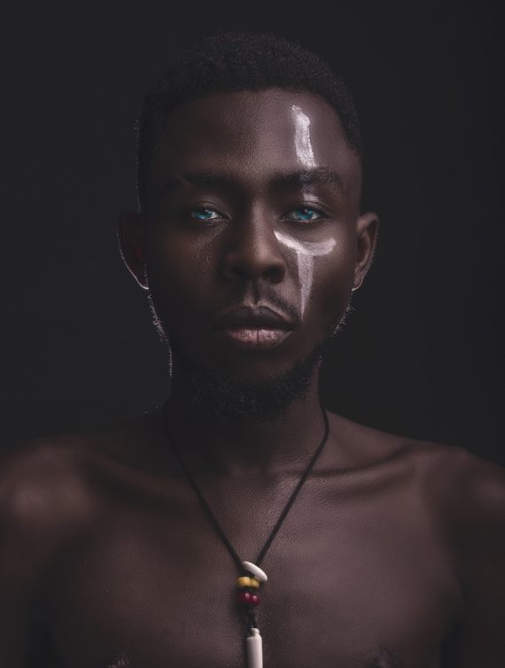 topless man wearing gold necklace